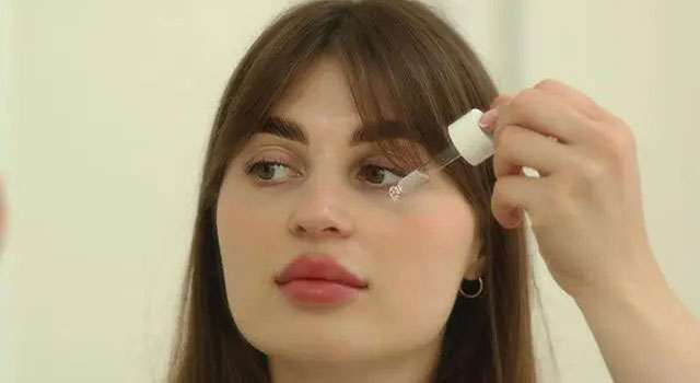 woman putting on eye drops